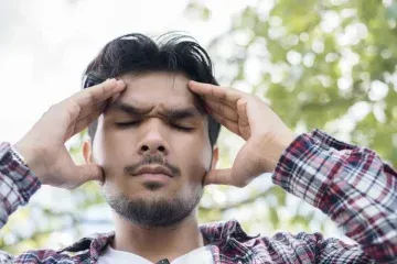 Man struggling with pain in his facial area
