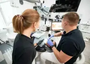 Dental team performing treatment using advanced equipment.