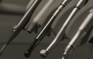 The image shows a variety of dental tools on a shelf in a dental office.