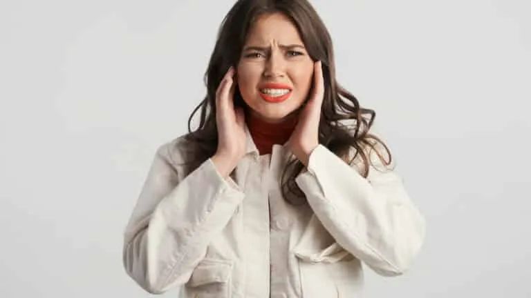 Woman in distress holding her head.
