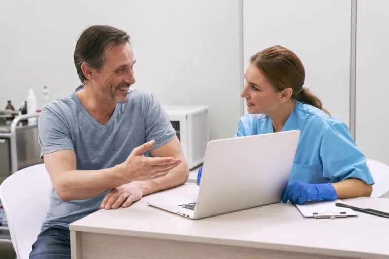 A man and a healthcare professional are engaging in a discussion.