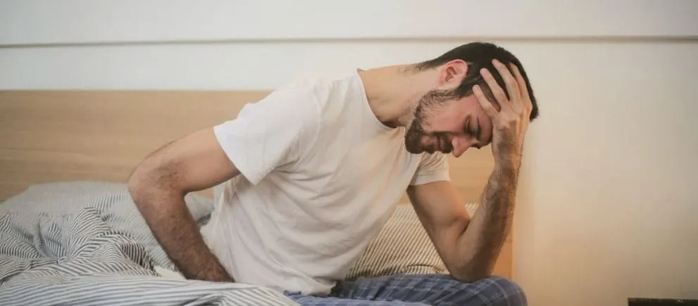 A image of man with a severe pain on his head