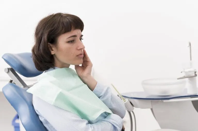female patient having toothache dentist-s office