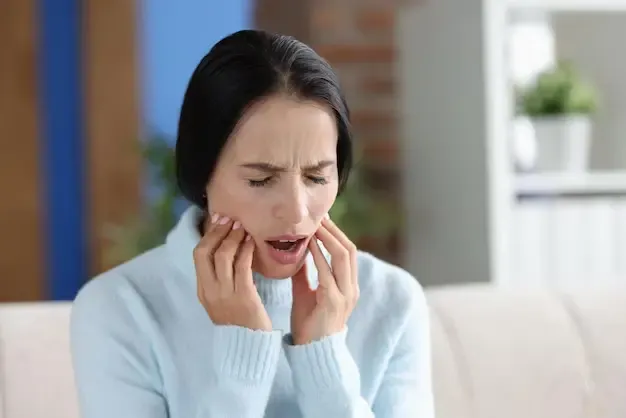 Young woman with severe jaw pain